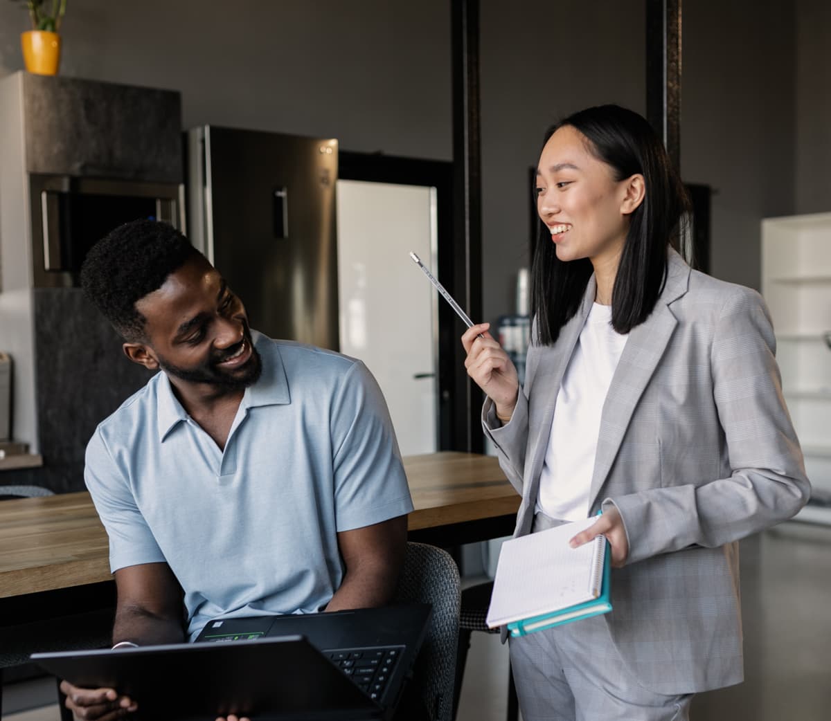 Co-workers talking inside an office.