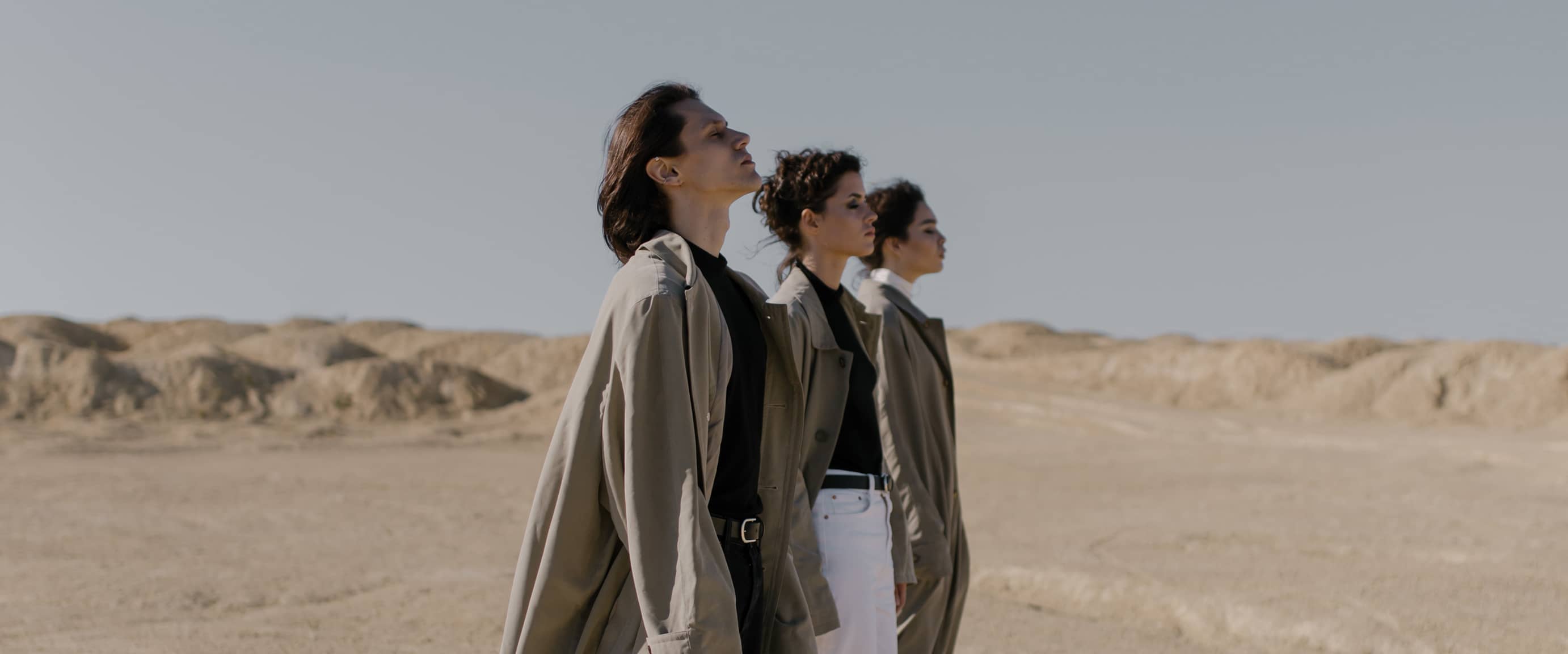 Three poeple looking into the distance.